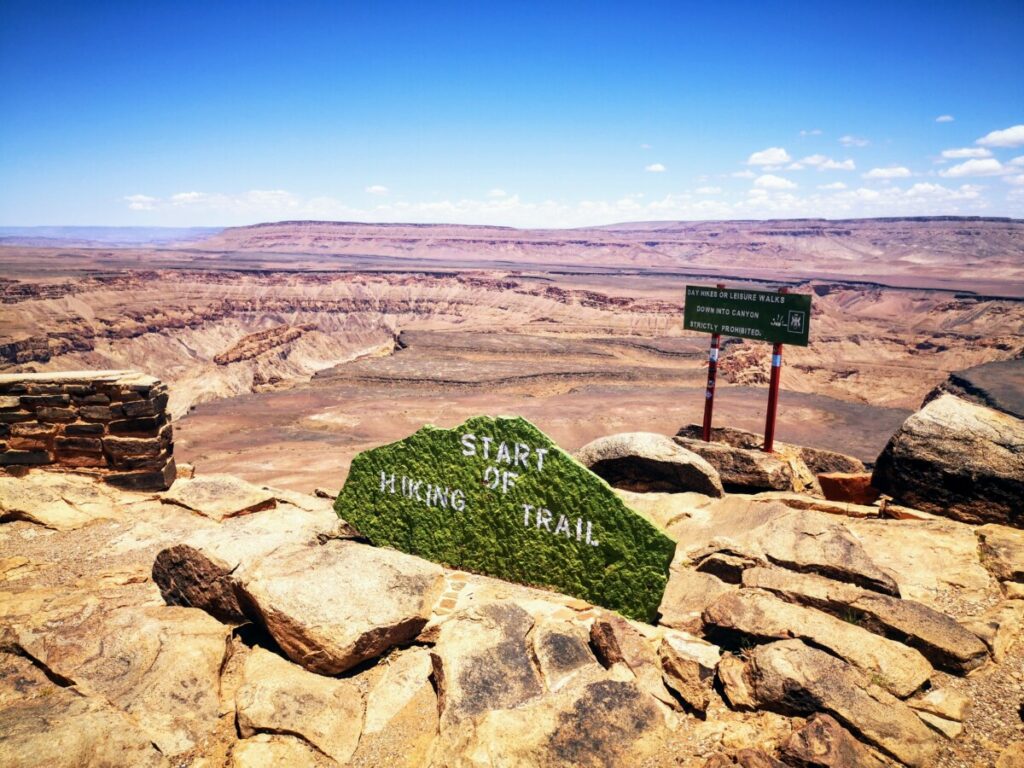 Hikers point at Fish River Canyon Hikers point at Fish River Canyon